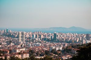 Stunning panoramic view of Istanbul's urban skyline with towering skyscrapers and the Bosphorus Strait.