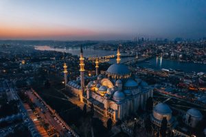 Stunning aerial view of Süleymaniye Mosque in Istanbul during sunset, showcasing the skyline and Bosphorus.