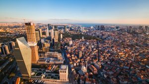 Stunning aerial view of Istanbul showcasing skyscrapers and historical streets at sunset.